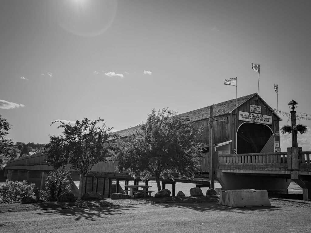 The world's longest covered bridge with three flags waving in the wind. 