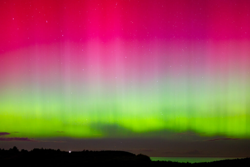 Aurora Borealis sky with layers of pink, purples and green.