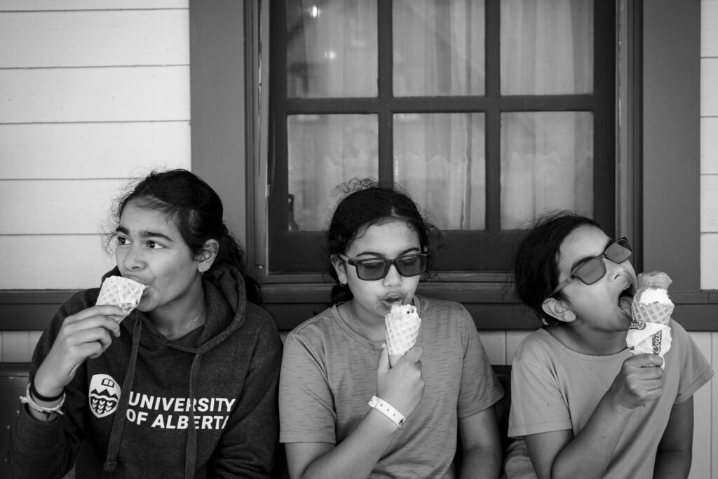Three girls enjoying ice cream cones. 