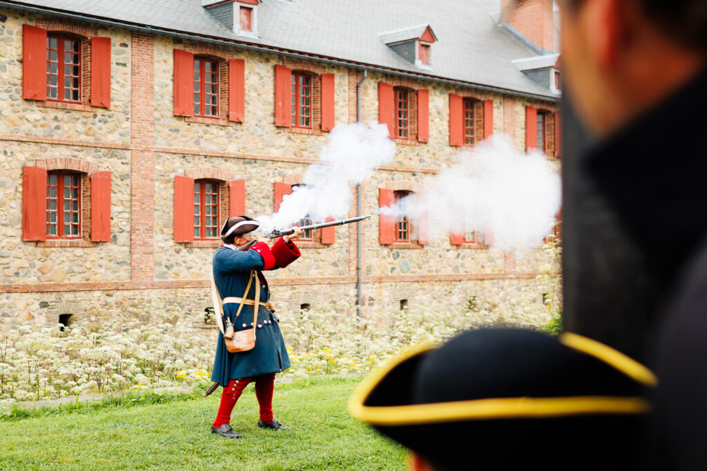 Father and son looking at a costumed animators firing a gun. 