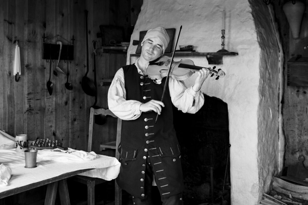 Costumed animators playing the violin. 