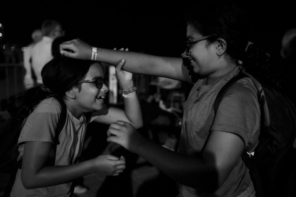 Two kids playing while waiting for fireworks. 